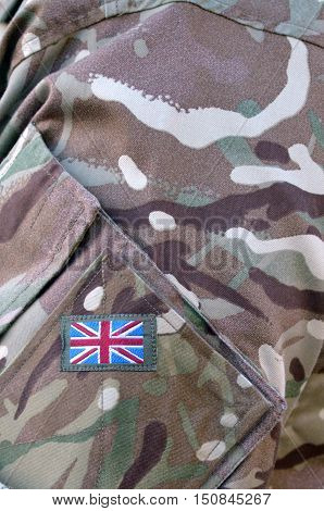 British Army soldier camouflage uniform with the national British Flag Badge on It. background texture