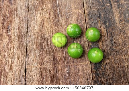 lemon with green on the wooden table top view