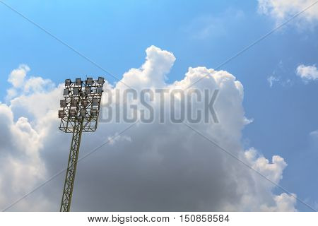 Sport stadium floodlights on a cloudy background. Soccer stadium lighting.