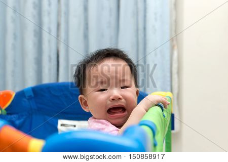 Asian Baby In Playpen