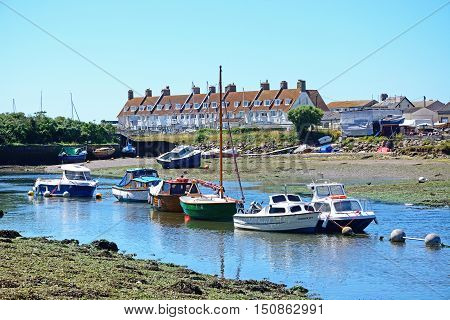 AXMOUTH, UNITED KINGDOM - JULY 18, 2016 - Fishing boats moored along the River Axe Axmouth Devon England UK Western Europe, July 18, 2016.