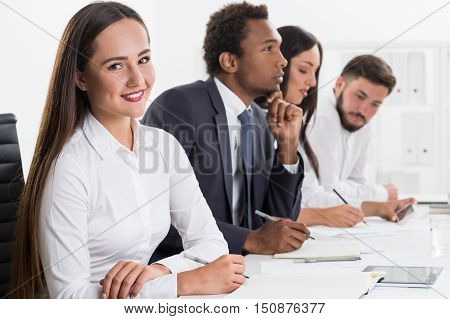 Smiling Girl And Her Colleagues