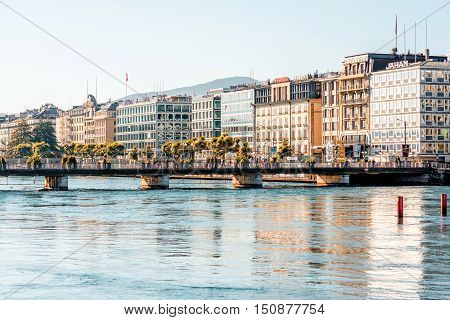 Geneva, Switzerland - June 23, 2016: Riverside buildings with offices of famous brands in the center of Geneva city. Geneva is a financial center and worldwide center for diplomacy in Europe