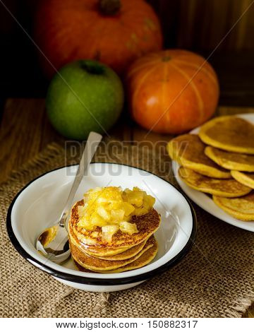 Pumpkin Pancake with apple and orange jam in a white plate with a spoon