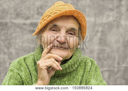 Portrait of a thoughtful elderly woman. Dreaming the past.
