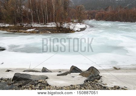 Icebound River On A Cloudy Spring Day. Irkutsk Region