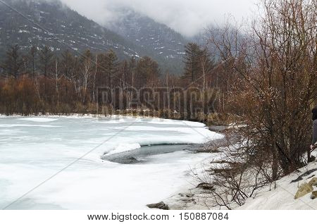 Icebound River On A Cloudy Spring Day. Irkutsk Region