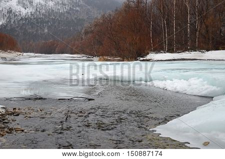 Icebound River On A Cloudy Spring Day. Irkutsk Region