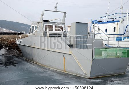 Ship And Fisher Boats On The Dock In Large Goloustnoye Village. Baikal Lake
