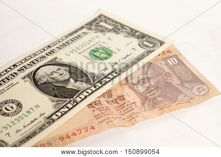 American one dollars and Indian ten rupee banknote on white background
