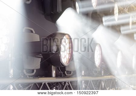 Stage lighting equipment. Concert spotlight. The direct rays of light in the haze.