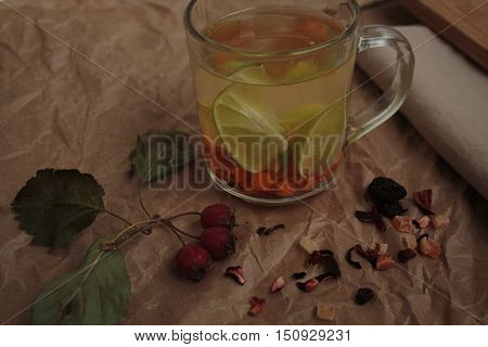 sea buckthorn tea in a transparent mug and a rose hip lime. useful warming winter drink.