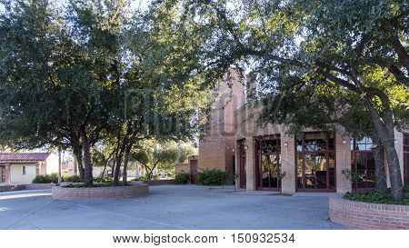 Classic red brick and mortar masonry used for walls on buildings tree and flower beds in Encanto Park Phoenix AZ