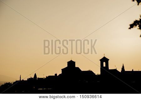 Skyline silhouette of the ancient part of a city against the evening sky