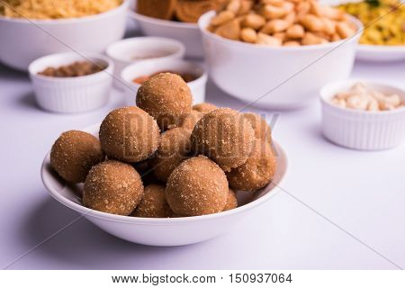 homemade tasty Diwali food or Diwali snacks or Diwali sweets like rava laddu, chakli, sev, shankar pale and chivda or chiwada with dry fruits in white bowls, favourite indian diwali recipe