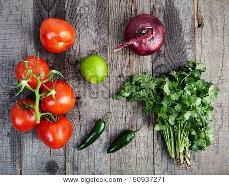 Ingredients for delicious, spicy sauce Pico de Gallo also called salsa Fresca. Traditional recipe, fresh tomatoes, red onion, cilantro, lime juice and spicy jalapenos. National Mexican cuisine.