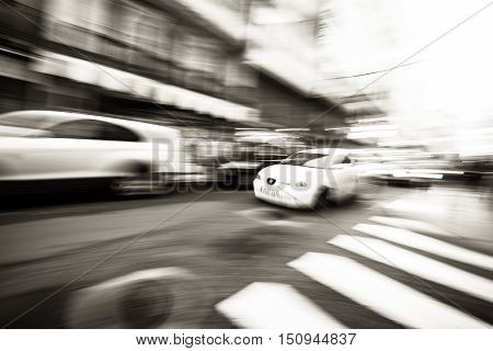 Panning following a car a pass by on a street