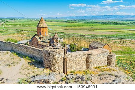 The historic Khor Virap Monastery surrounded by the fortress wall and located on the hill among Ararat Plain Pokr Vedi Armenia.