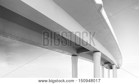 Underside of an elevated road in black and white colors
