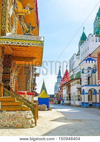 The colorful mansions wooden carved palaces and churches old-styled sculptures and patterns towers and weathervanes give to Izmailovsky Kremlin atmosphere of the fairy tale Moscow Russia.