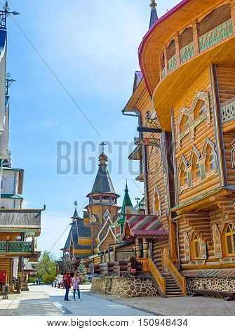 MOSCOW RUSSIA - MAY 10 2015: The timbered wall of Tsar's Palace in Izmailovsky Kremlin with the St Nicholas Church on the background on May 10 in Moscow.