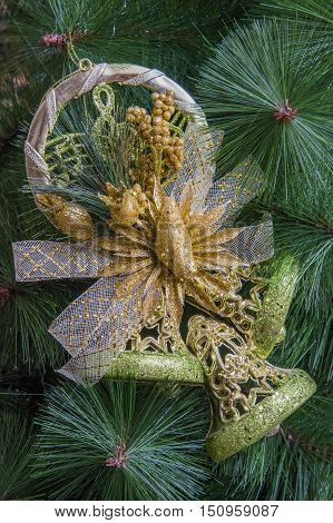 Christmas composition with golden bell and branch of christmas tree. Concept with copy space for text.