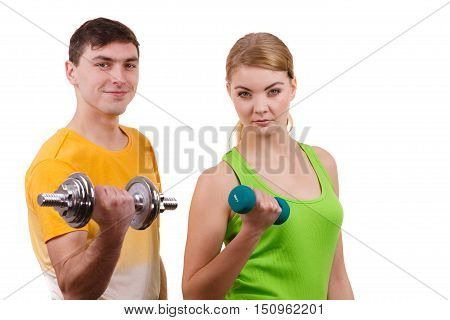 Couple fit woman and strong man exercising with dumbbells. Muscular guy and fitness blonde girl lifting weights. Bodybuilding.