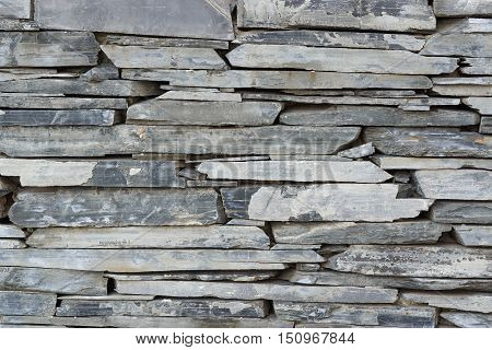Layer of stone plate arranged as a wall / Stone wall background