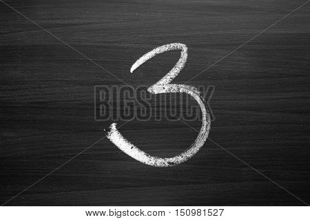 number three enumeration written with a chalk on the blackboard