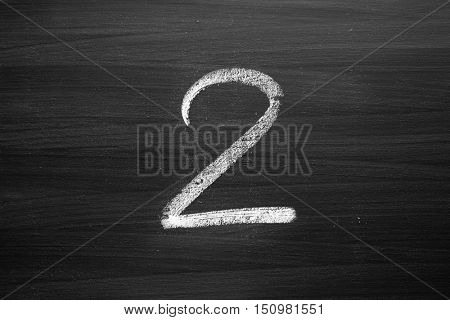 number two enumeration written with a chalk on the blackboard