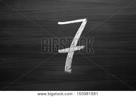 number seven enumeration written with a chalk on the blackboard