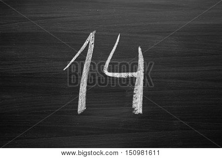 number fourteen enumeration written with a chalk on the blackboard