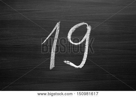 number nineteen enumeration written with a chalk on the blackboard