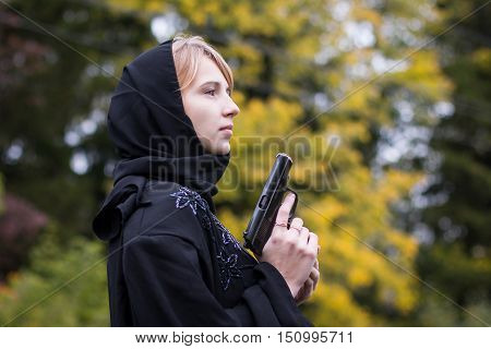 Muslim Woman With Arms In Autumn Day