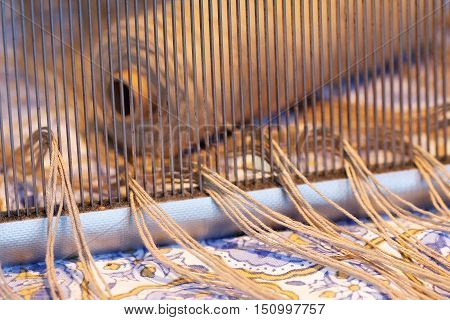 Preparing a loom before starting to make carpets. Warm light.