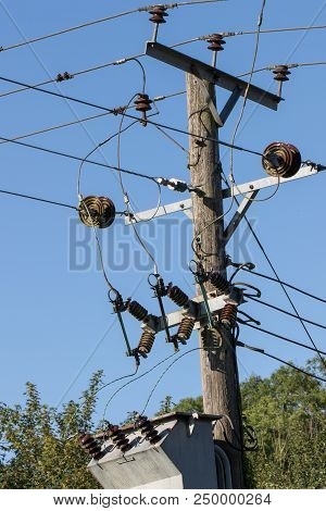 Elelctricity. Power Distribution Cable And Junction On Wooden Telegraph Pole In Rural England. Cabli