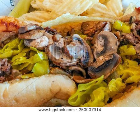 Mushrroms And Peppers On Cheese Steak With Potato Chips