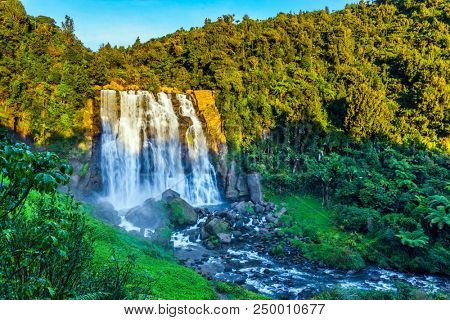 Marokopa falls at sunset. Concept of ecological and active tourism. Exotic journey to the North Island, New Zealand