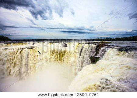 Spectacular journey to the grandiose exotic waterfalls. Grandiose waterfalls Iguazu in the rainy season. Garganta del Diablo. Concept of ecological tourism