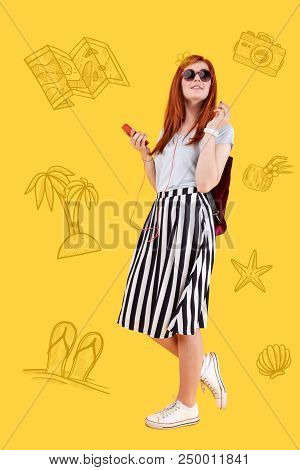 Favorite Song. Cheerful Young Girl Feeling Relaxed And Smiling While Walking And Listening To Her Fa