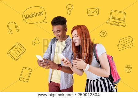 Interesting Webinar. Clever Active Students Standing Together With Modern Smartphone Sin Their Hands