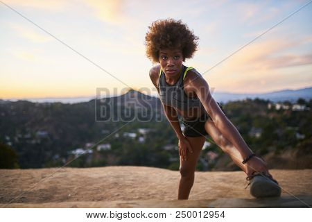 athletic african american woman doing stretches at runyon canyon