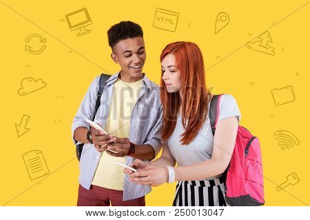 Sharing Interesting News. Positive Young Boy Smiling And Looking Glad While Standing With A Modern G