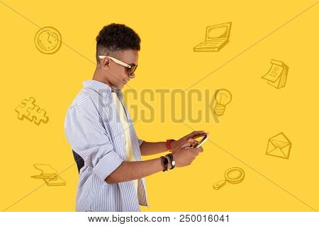 Person With Smartphone. Diligent Clever Student Smiling And Looking At The Smartphone In His Hands W