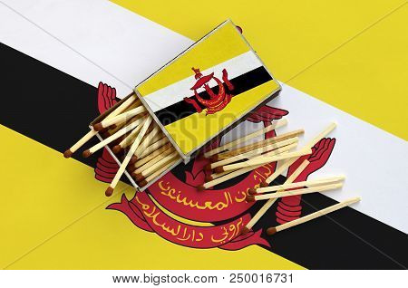 Brunei Darussalam Flag  Is Shown On An Open Matchbox, From Which Several Matches Fall And Lies On A 