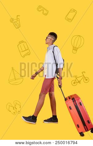 Confident Traveler. Cheerful Young Person Feeling Confident Abroad And Smiling While Walking With A 