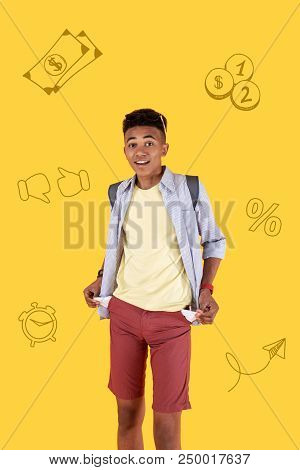 Empty Pockets. Emotional Student Showing His Empty Pockets And Looking Thoughtful While Having No Mo