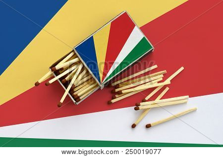 Seychelles Flag  Is Shown On An Open Matchbox, From Which Several Matches Fall And Lies On A Large F