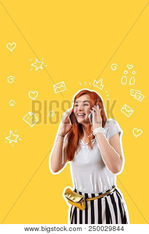 Exciting Phone Talk. Positive Young Girl Having A Birthday And Smiling While Getting Greetings On Tw