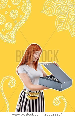 Unusual Present. Calm Young Girl Feeling Pleased While Opening A Big Box And Looking At The Beautifu